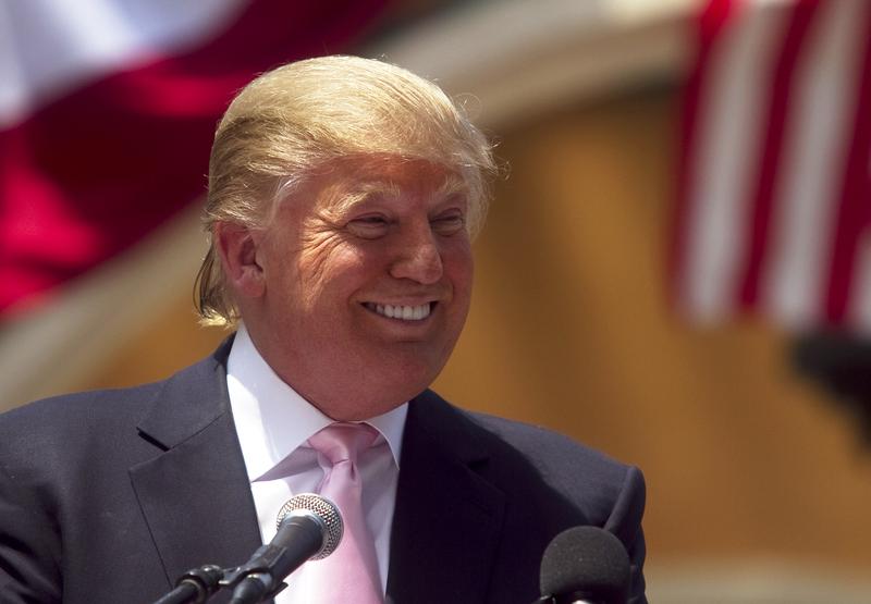 Billionaire Donald Trump laughs while speaking to a crowd at the 2011 Palm Beach County Tax Day Tea Party on April 16, 2011 at Sanborn Square in Boca Raton, Florida.